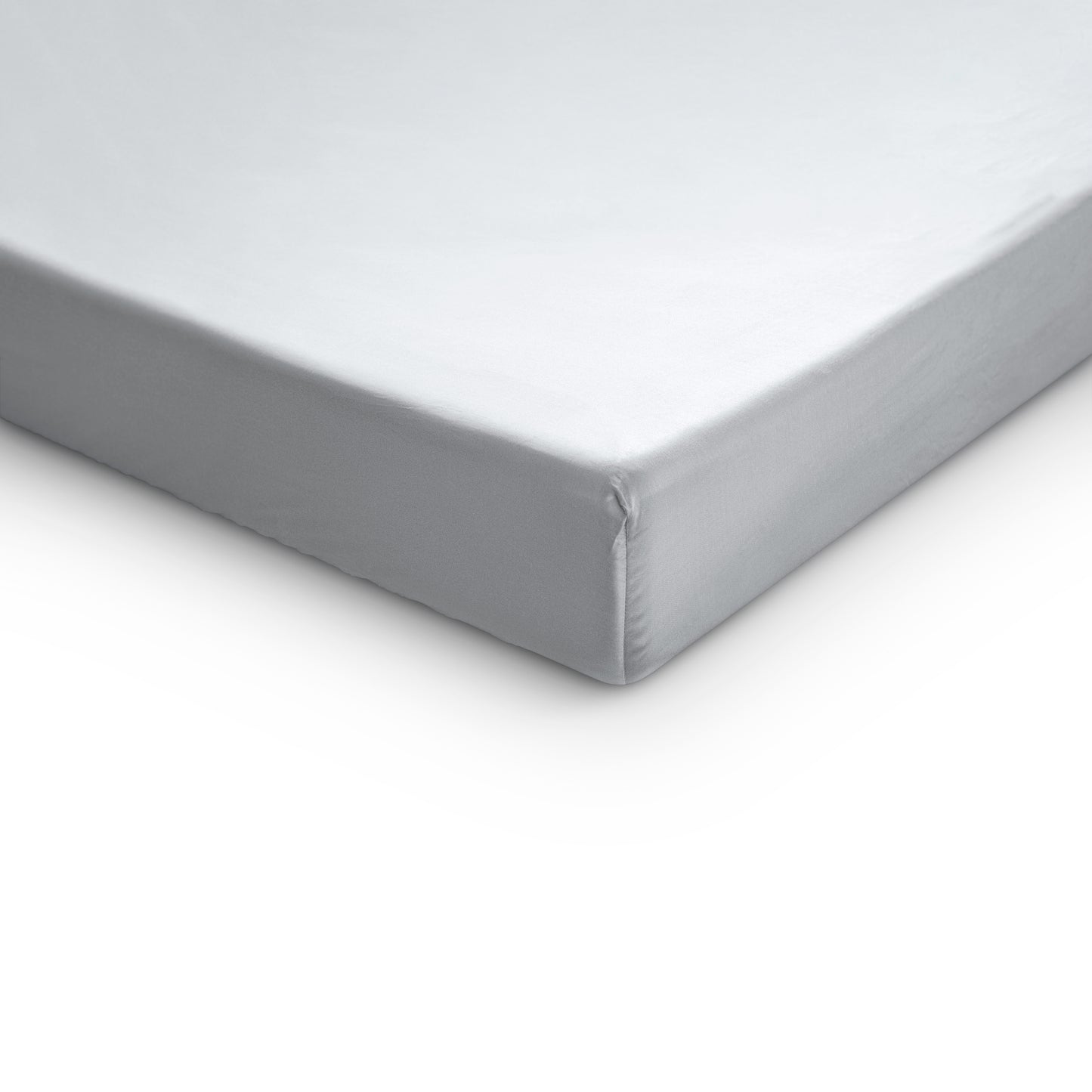 A close-up image of a white satin cotton fitted sheet on a mattress, highlighting its soft texture and elastic edge.