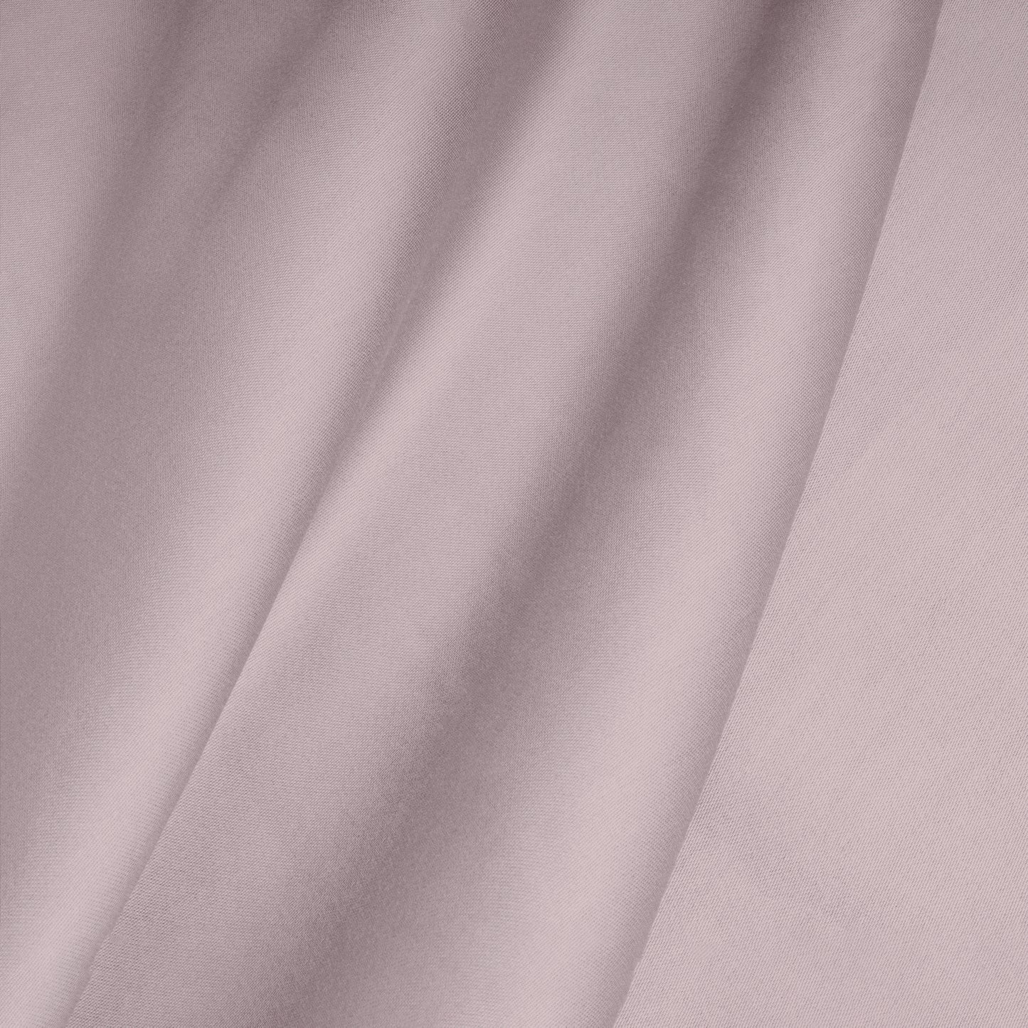 Close-up of a smooth, pink cotton satin fabric with folds.