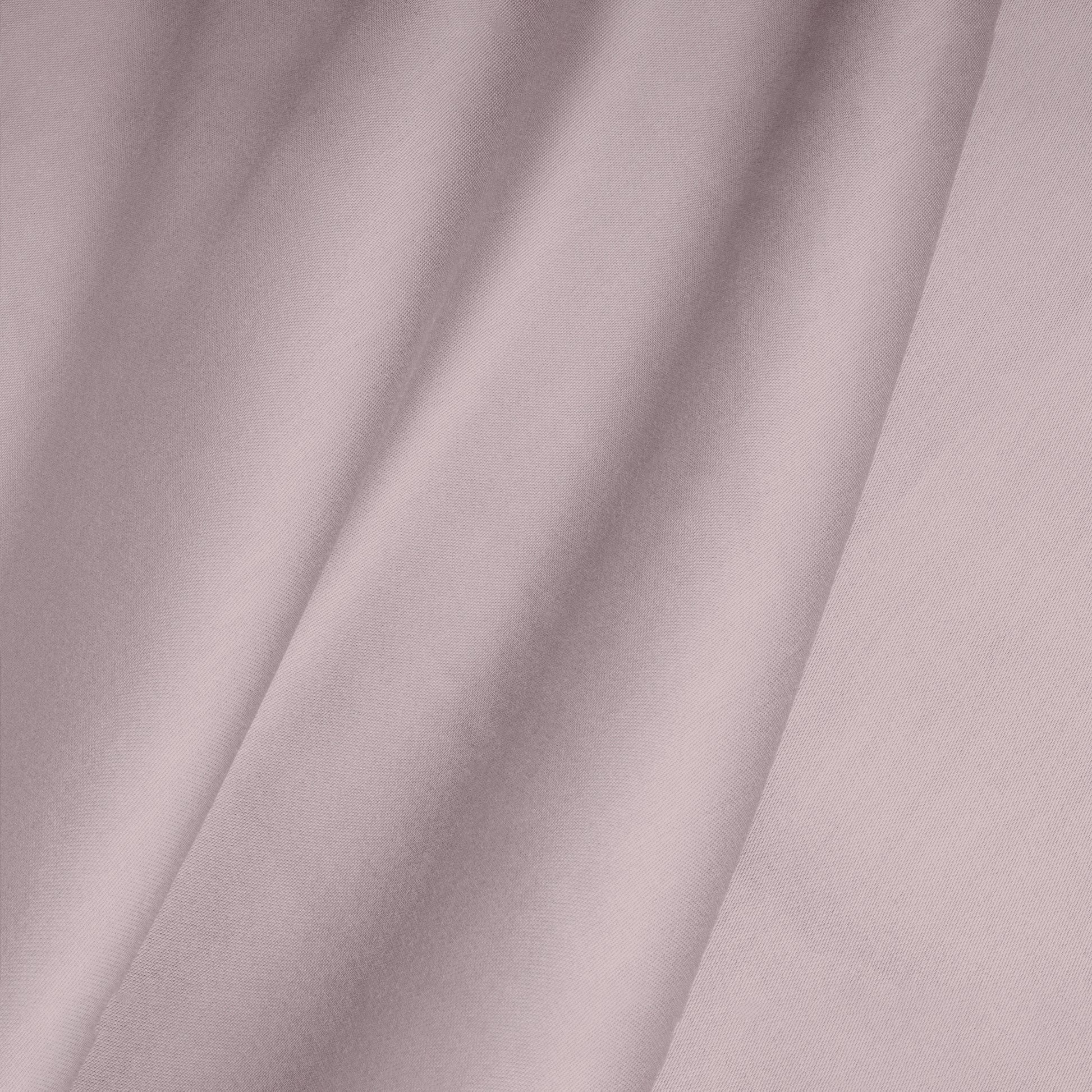 Close-up of a smooth, pink cotton satin fabric with folds.